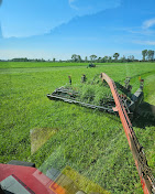 Deering Farms LLC's equipment efficiently harvesting crops for sustainable agriculture.