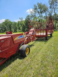 A modern harvesting machine at Deering Farms LLC collecting quality crops in a sustainable agricultural field.