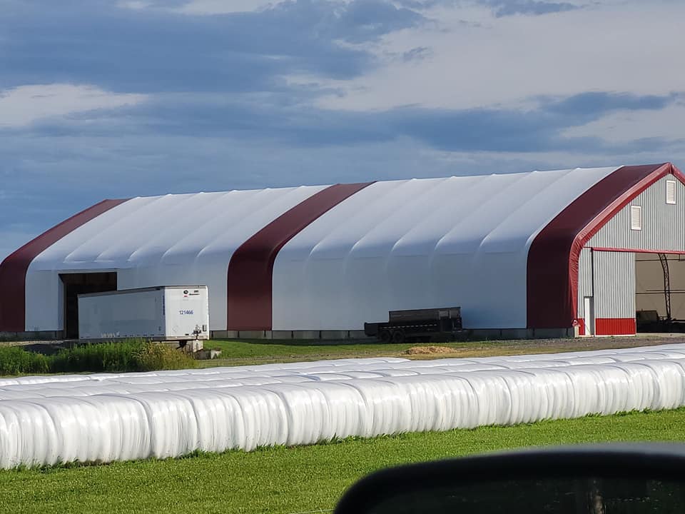 Image of Deering Farms LLC with non-GMO beef, chicken, organic eggs, and vibrant hay in a scenic farm setting.