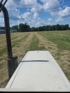 Modern harvesting equipment at Deering Farms LLC efficiently collecting crops, showcasing sustainable agricultural practices.