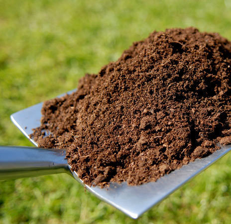 Rich, dark topsoil piled at Deering Farms, showcasing nutrient-rich earth for gardening and agriculture.